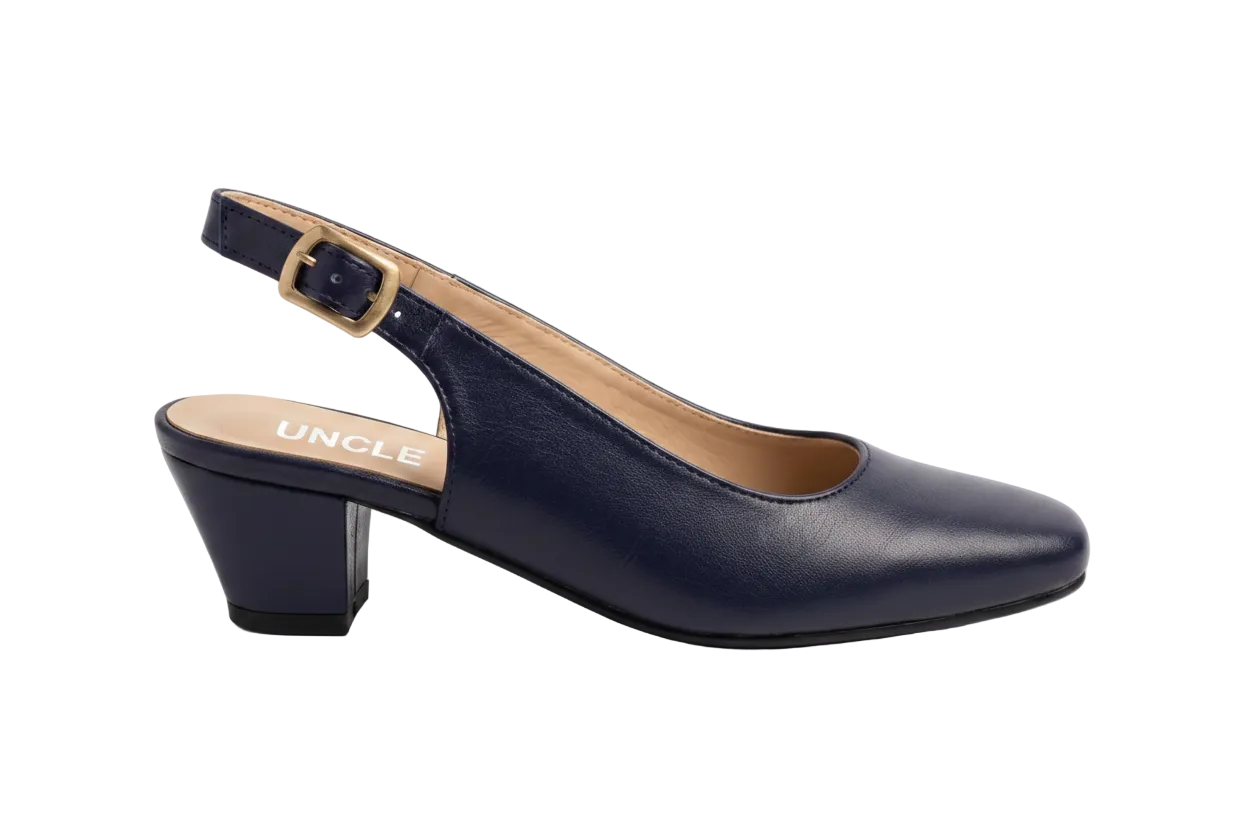 A single navy blue leather slingback pump with a low block heel and a gold buckle, shown in profile on a white marble background. The brand name 'UNCLE' is printed on the insole.