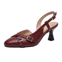 A single women's slingback pump in deep burgundy faux leather, featuring two decorative buckle straps across the instep, a pointed toe, and a black kitten heel, shown on a plain white background.