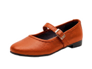 A single women's Mary Jane flat shoe in textured cognac brown faux leather, featuring a strap with a silver-tone buckle and a low black heel, shown on a white background.