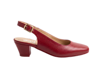 A single red leather slingback pump with a low block heel and gold buckle, shown in profile against a white marble background. The brand name 'UNCLE' is printed on the insole.