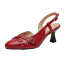 A red leather slingback pump with a kitten heel, double buckle straps across the instep, and a pointed toe, shown on a white background.