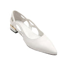 A white pointed-toe slingback flat shoe with cutout details on the upper and a low block heel, photographed on a clean white background.