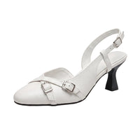 A white faux leather slingback kitten heel shoe with a pointed toe, featuring two adjustable buckle straps across the instep and a black block heel, shown on a white background.