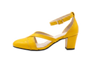 A bright yellow leather block-heel sandal with an ankle strap and crossover front straps, shown in profile against a white background with a motion blur effect near the ankle strap.